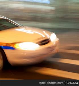 Blurred image of the front of a car on the streets of Manhattan, New York City, U.S.A.