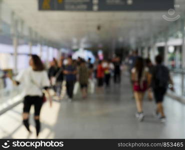 Blurred image of the people are walking on the floating bridge.