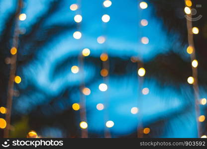 blurred light bokeh with coconut palm tree background on sunset