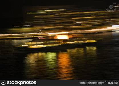 Blurred lights at night reflected on Sydney Harbour in Sydney, Australia.