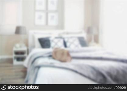 blurred modern bedroom with white bed