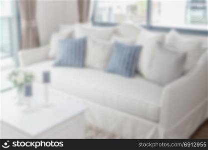 blurred modern living room with row of pillows on sofa for background