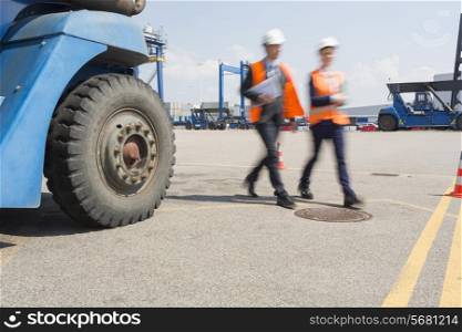 Blurred motion of workers walking in shipping yard