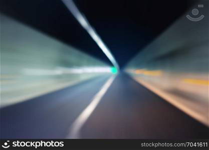 Blurred motion through dark tunnel