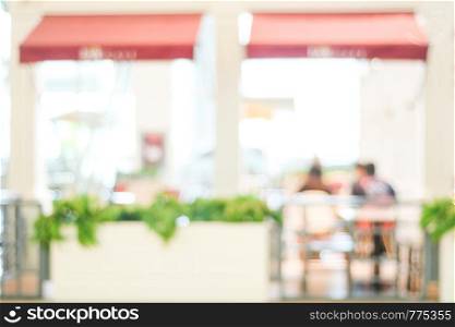 Blurred people background : blur people at cafe with bokeh light background, banner, food and drink concept