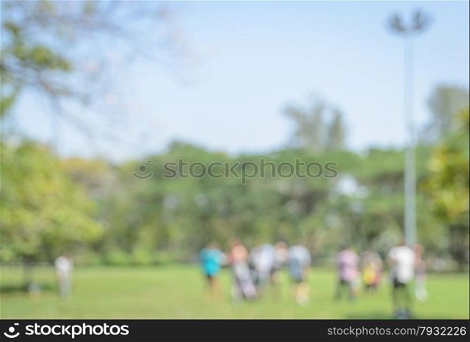 Blurred people background having activities in green park