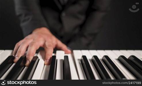 blurred person playing digital piano