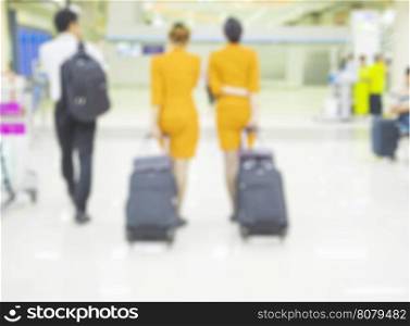 Blurred photo of aircraft crew is walking in airport terminal