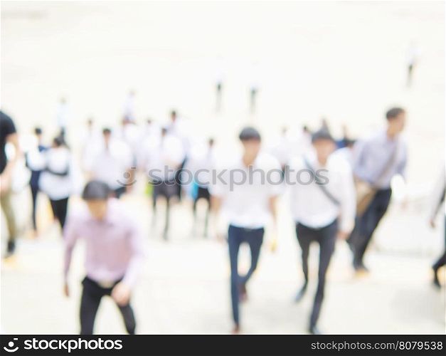 Blurred photo of crowded people is walking upstair