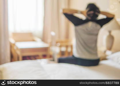 Blurred photo of stressed man in hotel room