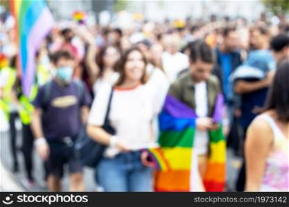 Blurred photo of unrecognizable participants of LGBT parade. Gay pride.