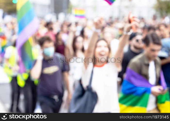 Blurred photo of unrecognizable participants of LGBT parade. Gay pride.