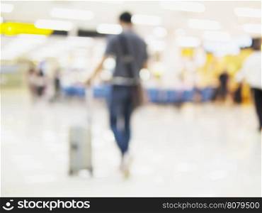 Blurred photo of walking traveler in airport terminal