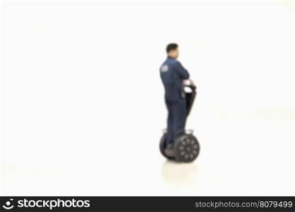 Blurred photo to patrolling police on segway two-wheeled personal transporter