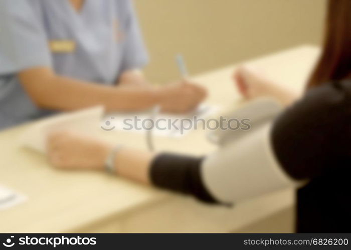 blurred picture, nurse measuring blood pressure of patient