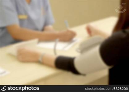 blurred picture, nurse measuring blood pressure of patient