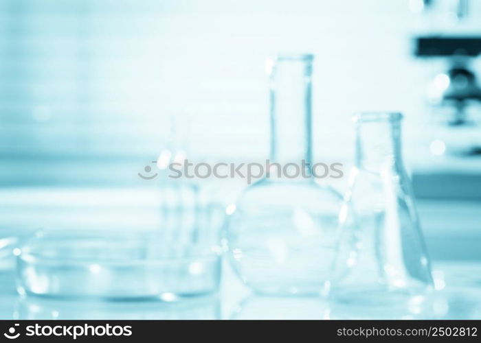 Blurred science background, test tubes and microscope, research concept