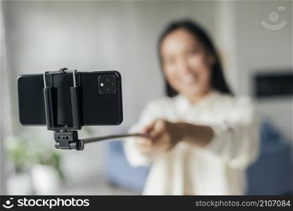 blurred smiley woman doing vlog