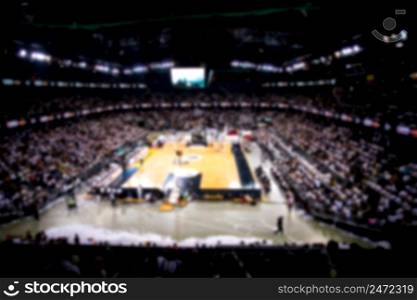 blurred supporters crowd in a basketball court during game