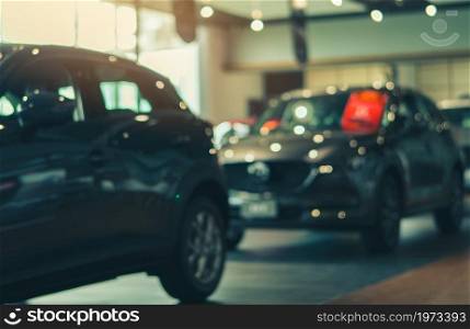 Blurred SUV car parked in luxury showroom. Car dealership office. New car parked in modern showroom. Car for sale and rent business. Automobile leasing and insurance background. Automotive industry.