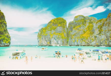 blurred tourist on white sand beach at maya bay, phi phi leh island, thailand - vintage tone