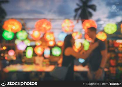 blurred tourist with decorative lamp at chiangmai night market walking street,Thailand