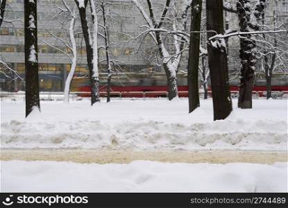 Blurred tram in the background of a wintery scene in Poland.