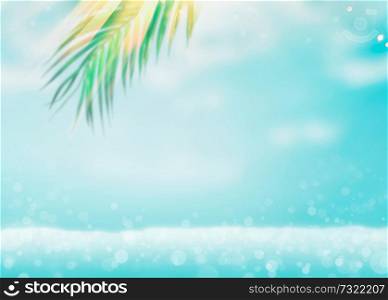 Blurred tropical summer sea vacation background with hanging green palm leaves at beach with water bokeh and sun light. Travel concept