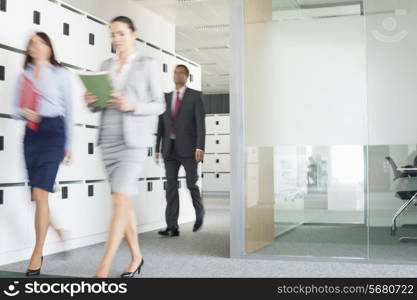 Blurred view of businesswomen walking in office