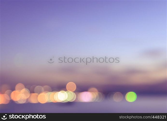Blurred view of city bokeh on a shore with pink sky background