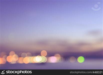 Blurred view of city bokeh on a shore with pink sky background
