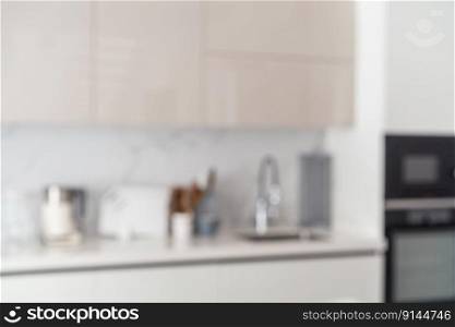 Blurred view of modern kitchen with white furniture. Blurred view of modern kitchen