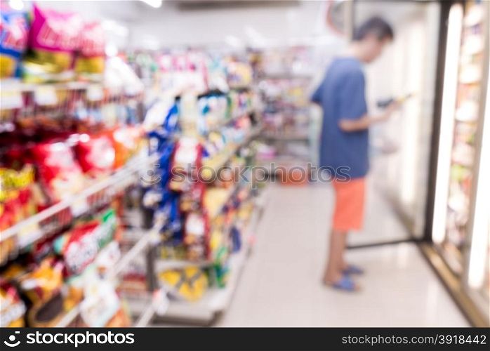 Blurred view of people in supermarket while shopping