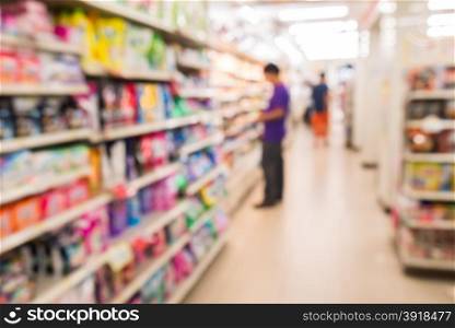 Blurred view of people in supermarket while shopping