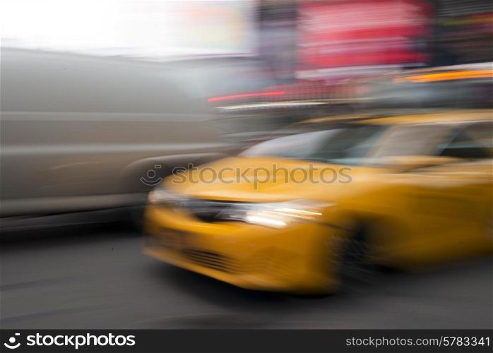 Blurred view of Yellow taxi moving in Times Square, Manhattan, New York City, New York State, USA