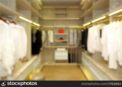 blurred wide dressing room with wardrobe in modern house as background