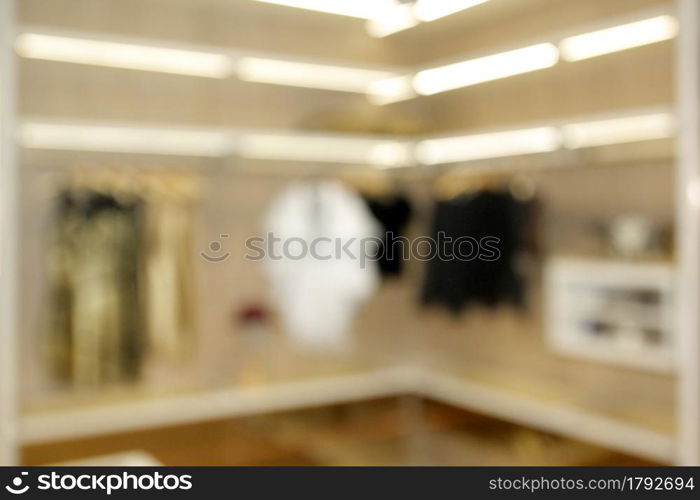 blurred wide dressing room with wardrobe in modern house as background