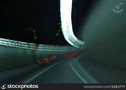 Blurring car lights in road tunnel.