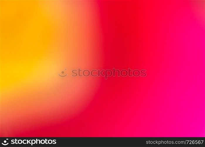 Blurry and defocused photo of flower in red and yellow colors. Abstract background with directional blur