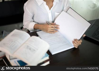 Blurry and soft focus of Asian women student reading a book for relaxation and final exam