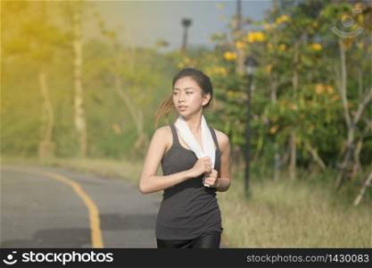 Blurry and soft focus of Running woman. Female runner jogging during outdoor on road .