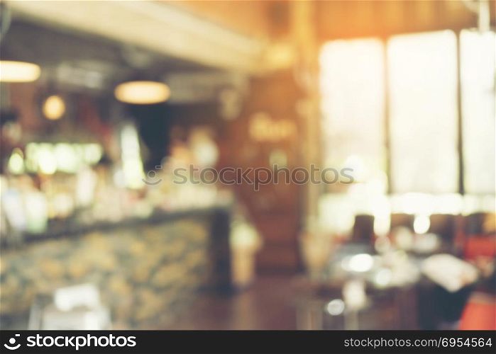 blurry background of coffee cafe with vintage light tone