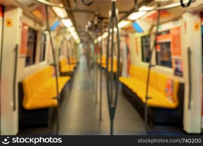 blurry background of empty interior inside of the public transport train, subway, or metro in mass rapid transit.