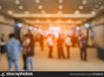 Blurry background of exhibition expo with crowd people in convention hall. Abstract concept. Business marketing and event theme.
