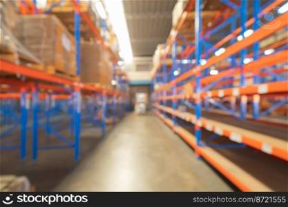 Blurry bokeh abstract background of interior of large warehouse retail store industry. Rack of furniture and home accessories stock storage. Interior of cargo in ecommerce and logistic concept. Depot