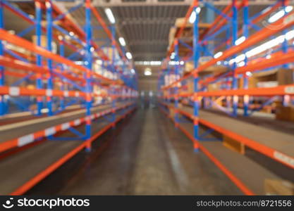 Blurry bokeh abstract background of interior of large warehouse retail store industry. Rack of furniture and home accessories stock storage. Interior of cargo in ecommerce and logistic concept. Depot