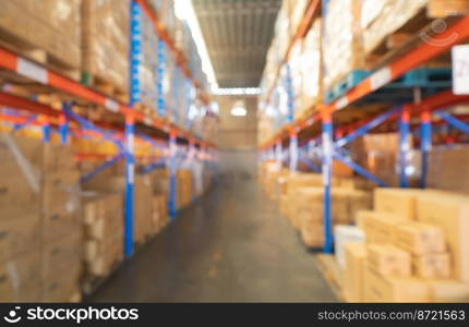 Blurry bokeh abstract background of interior of large warehouse retail store industry. Rack of furniture and home accessories stock storage. Interior of cargo in ecommerce and logistic concept. Depot