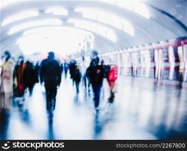 Blurry image of a platform with passengers waiting for the train.