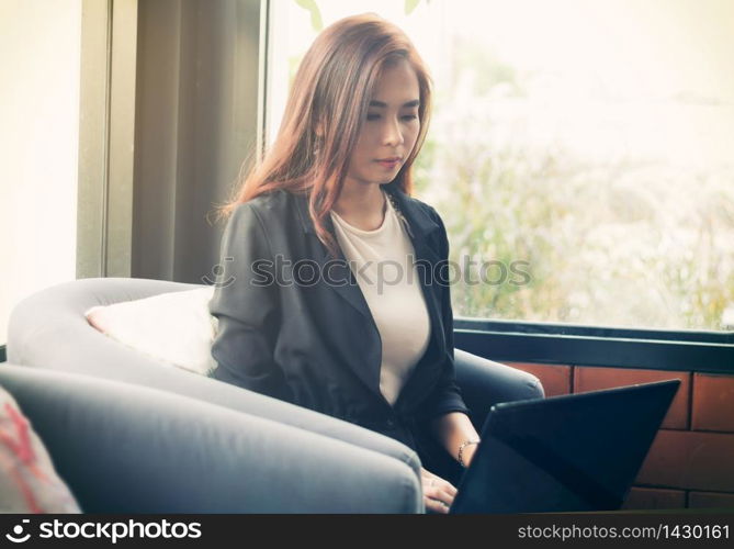Blurry of Asian business women using notebook for working ,soft focus ,vintage tone