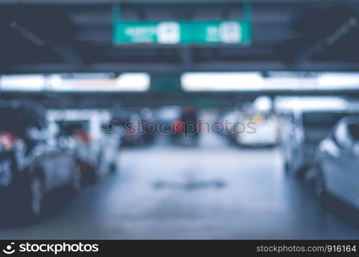 Blurry of car parking lots at department store. Abstract and transportation concept. Dark and low key tone